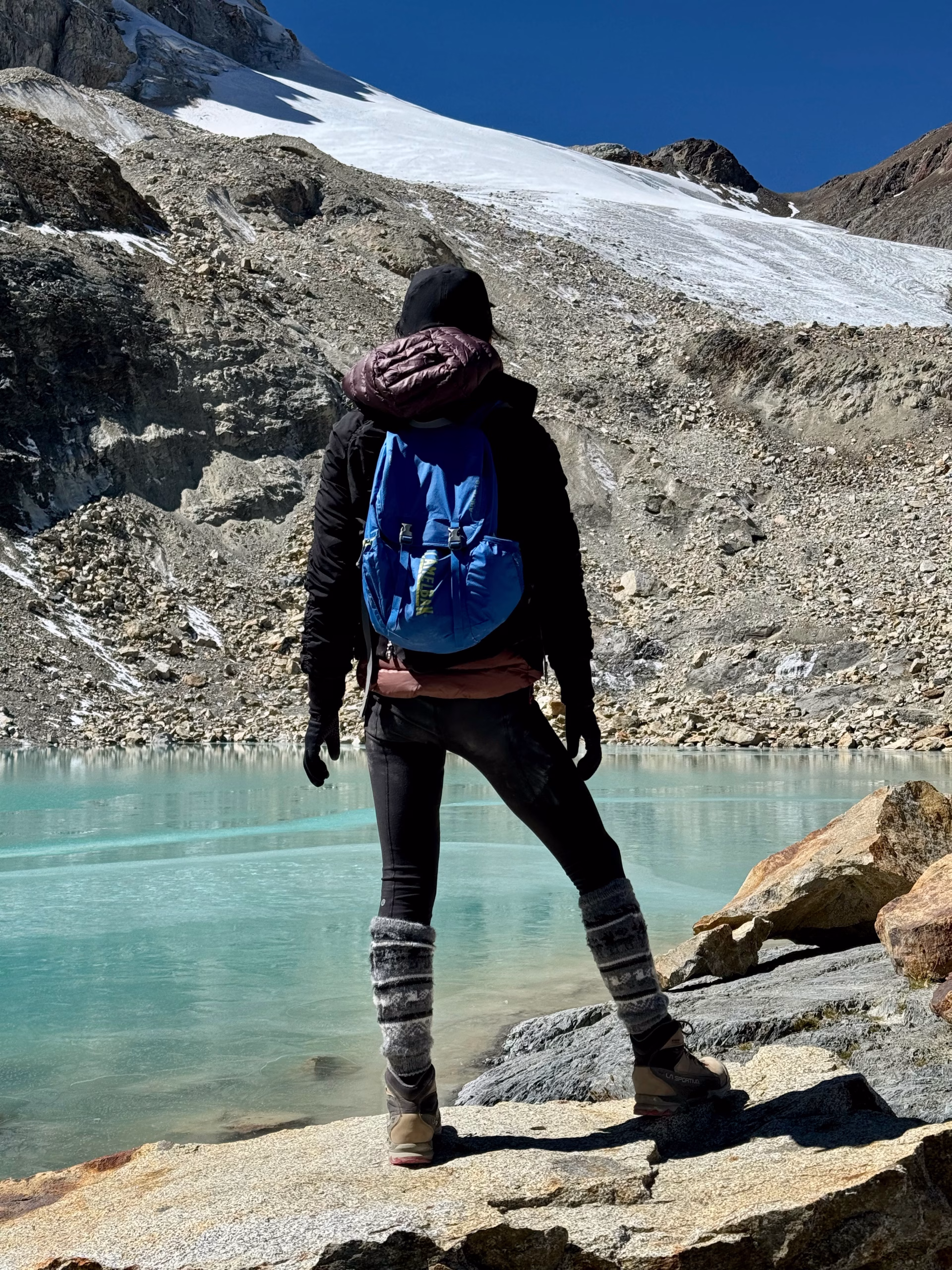 Kathy is standing in front of Emerald Lagoon of Nevado Charquini, Bolivia